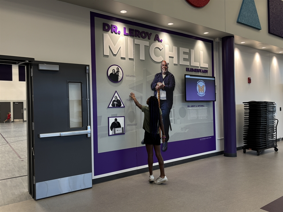 Student looking at Mitchell Mural wall Student looking at Mitchell Mural wall