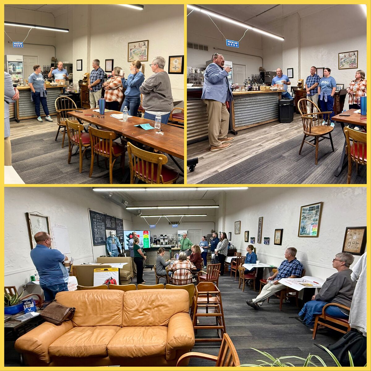 A group of people gather in a cafe-like setting, some listening to a speaker.