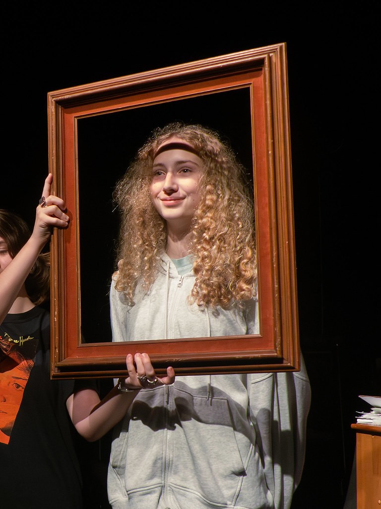 actor with frame held around her face