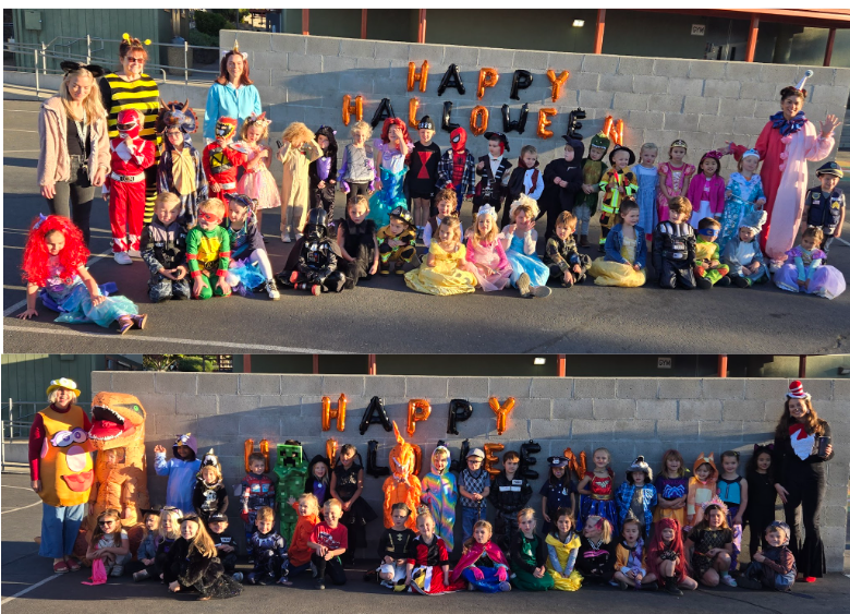 A group of children and adults in costumes pose for a Halloween photo.