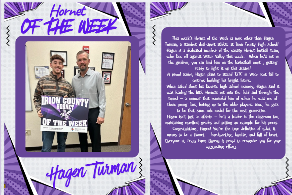 Two men pose with a 'Hornet of the Week' award in a school setting.