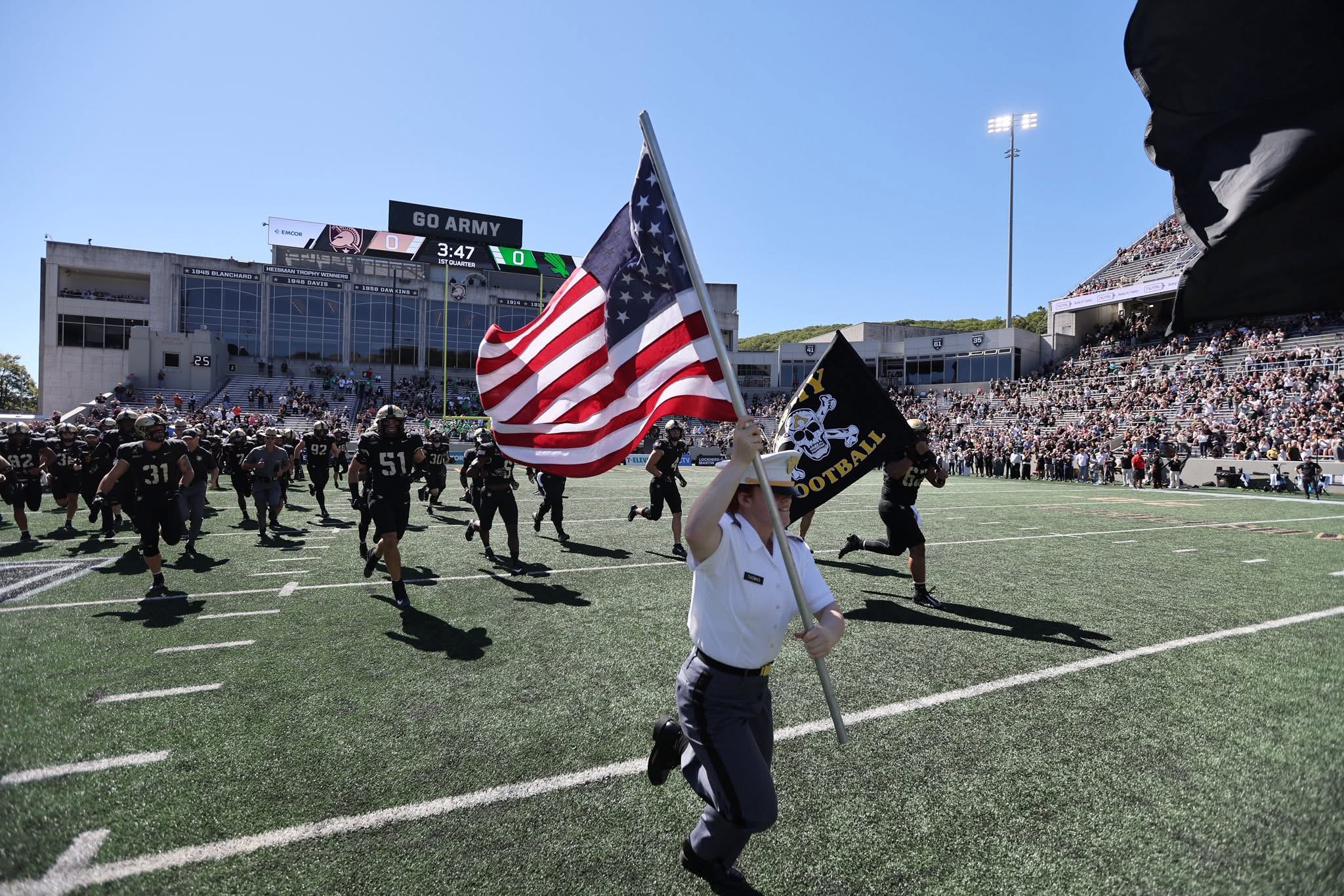 Analia Thomas running the U.S. flag at the Army game