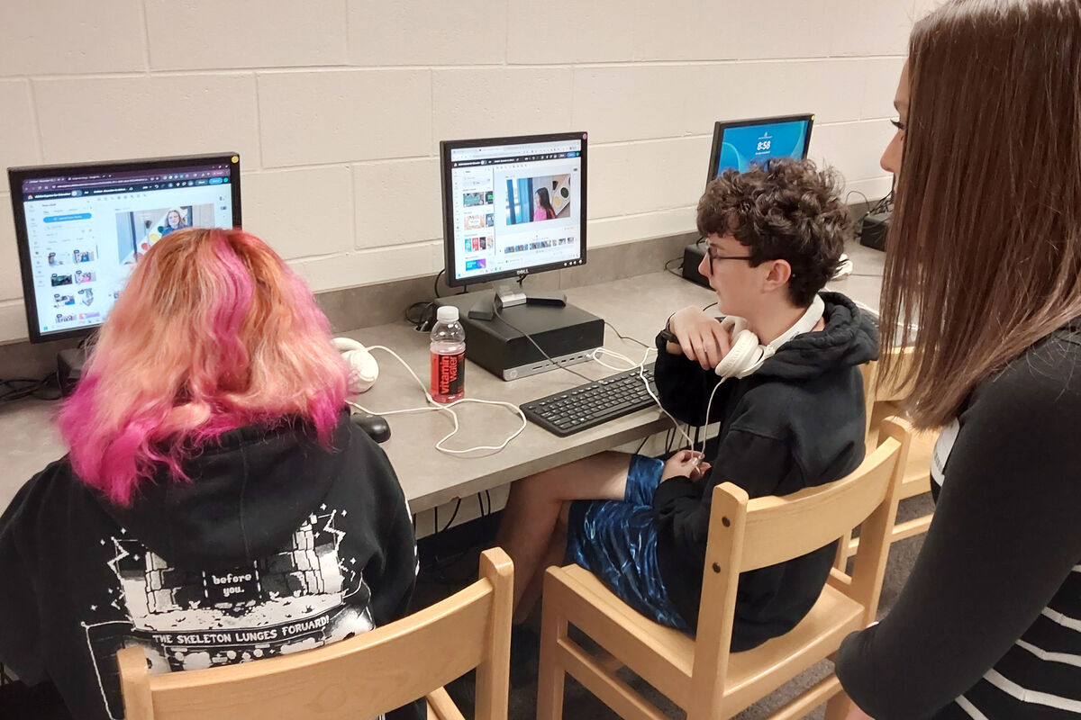 KCTV5 reporter Katie Byrd, far right, reviews a video that is being produced by a digital media student at Kearney Junior High.