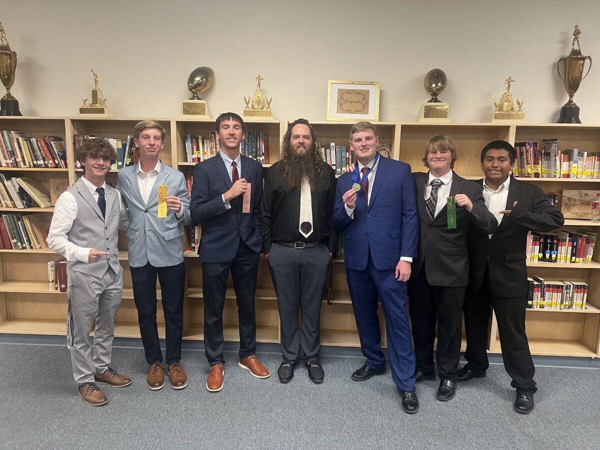 The BHS Debate team poses with Coach Justin Moore.