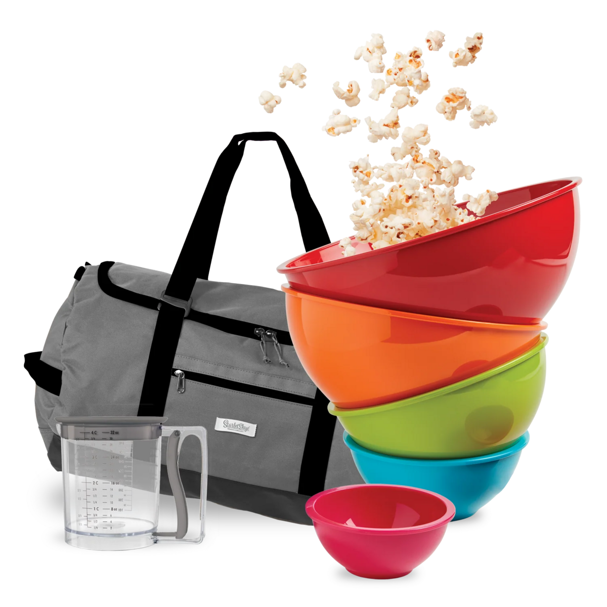 A stack of colorful bowls with popcorn spilling out, next to a gray bag.