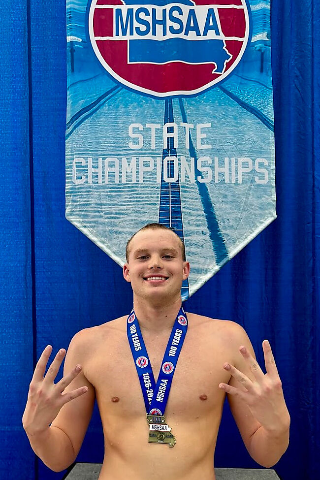 KHS swimmer Whitaker Steward poses on the podium after winning the 500 free race at the 2025 state championships.