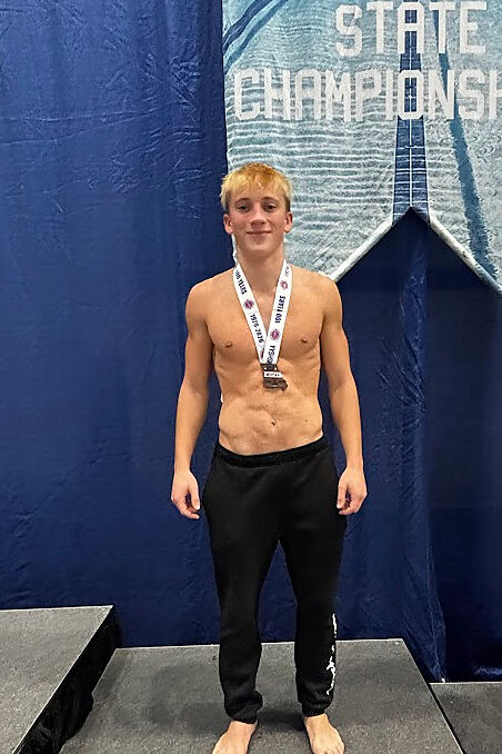 KHS diver Isaac Clayton poses on the podium after taking fifth at State.