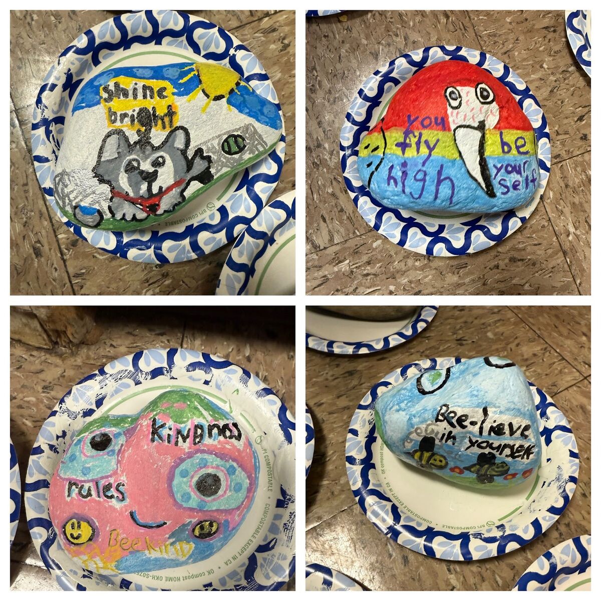Painted rocks with positive messages and colorful designs rest on paper plates.