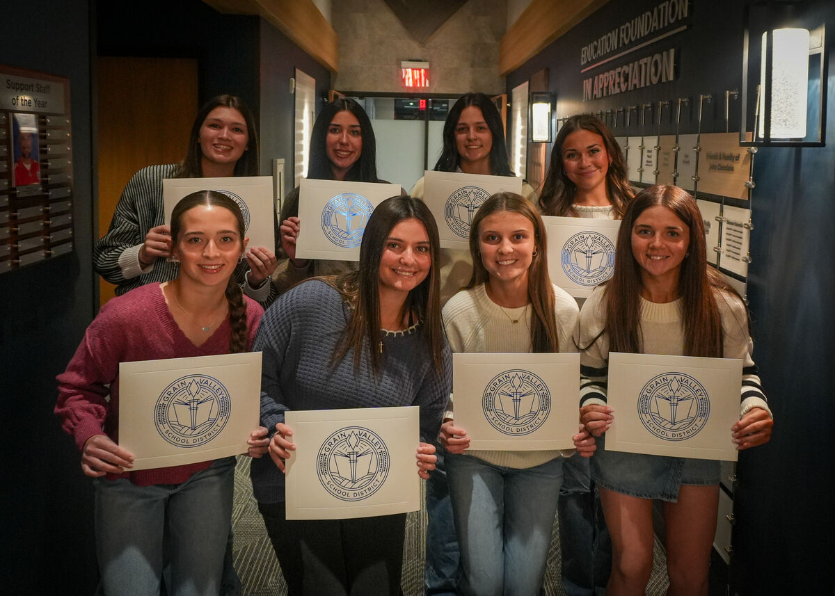 A photo of the GVHS Varsity softball players holding an award at the Board meeting. 