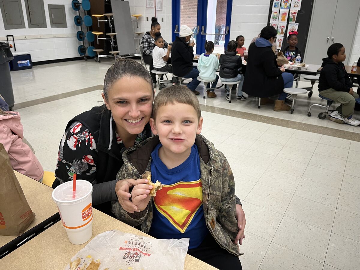A mom eats breakfast with her child