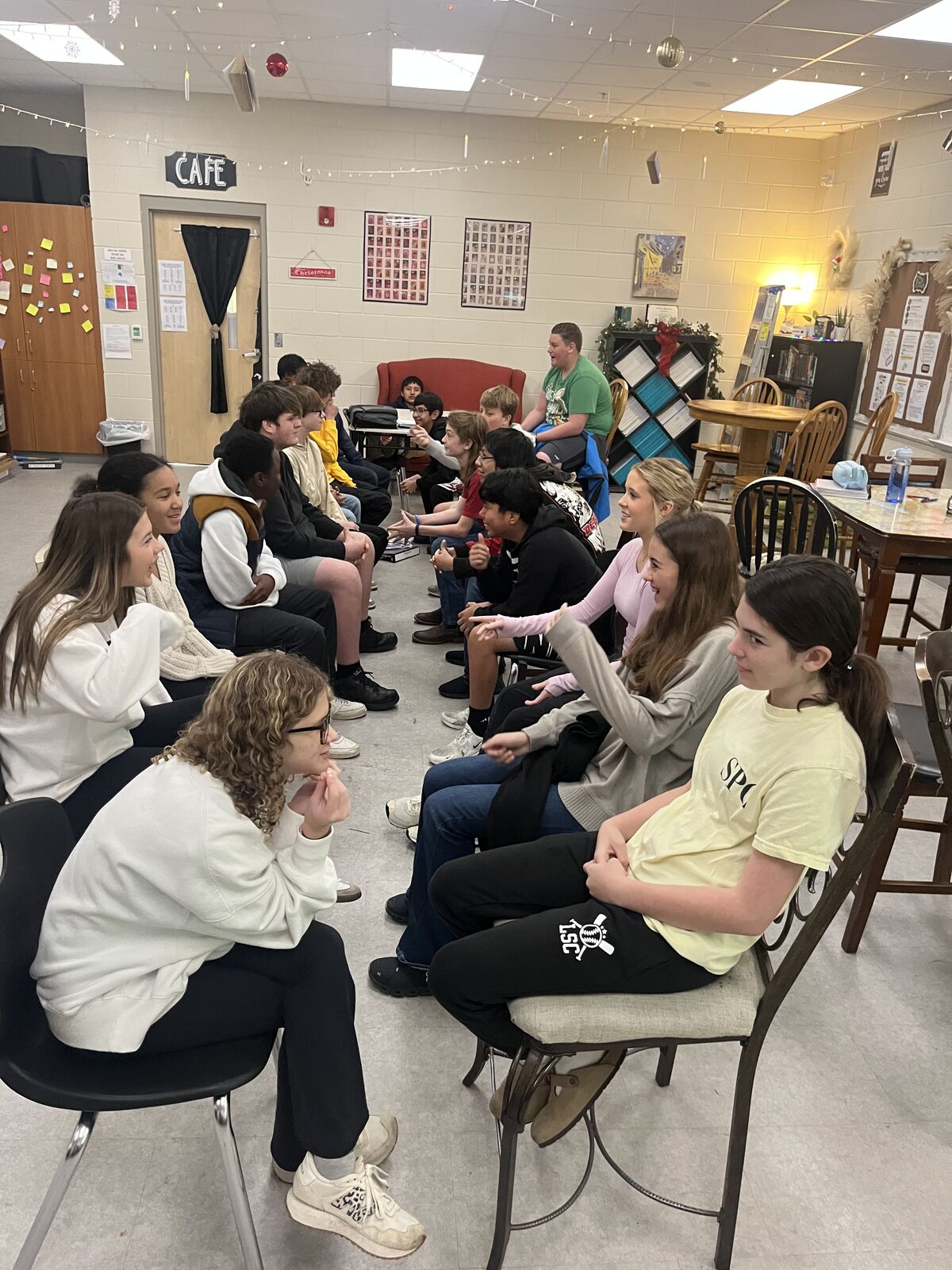 A group of students are seated in a classroom, engaged in an activity.