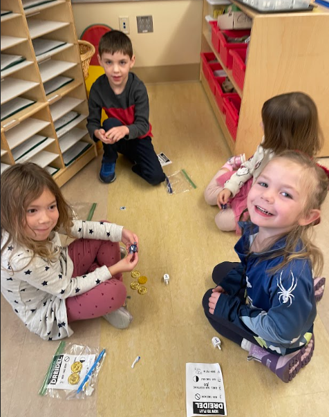 Students play the dreidel game