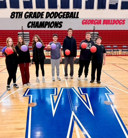 The "Georgia Bulldogs" 8th Grade Dodgeball Champions pose with dodgeballs.