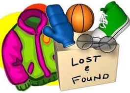 A cardboard box labeled 'LOST & FOUND' contains a basketball, glasses, a blue glove, and a green and pink jacket.