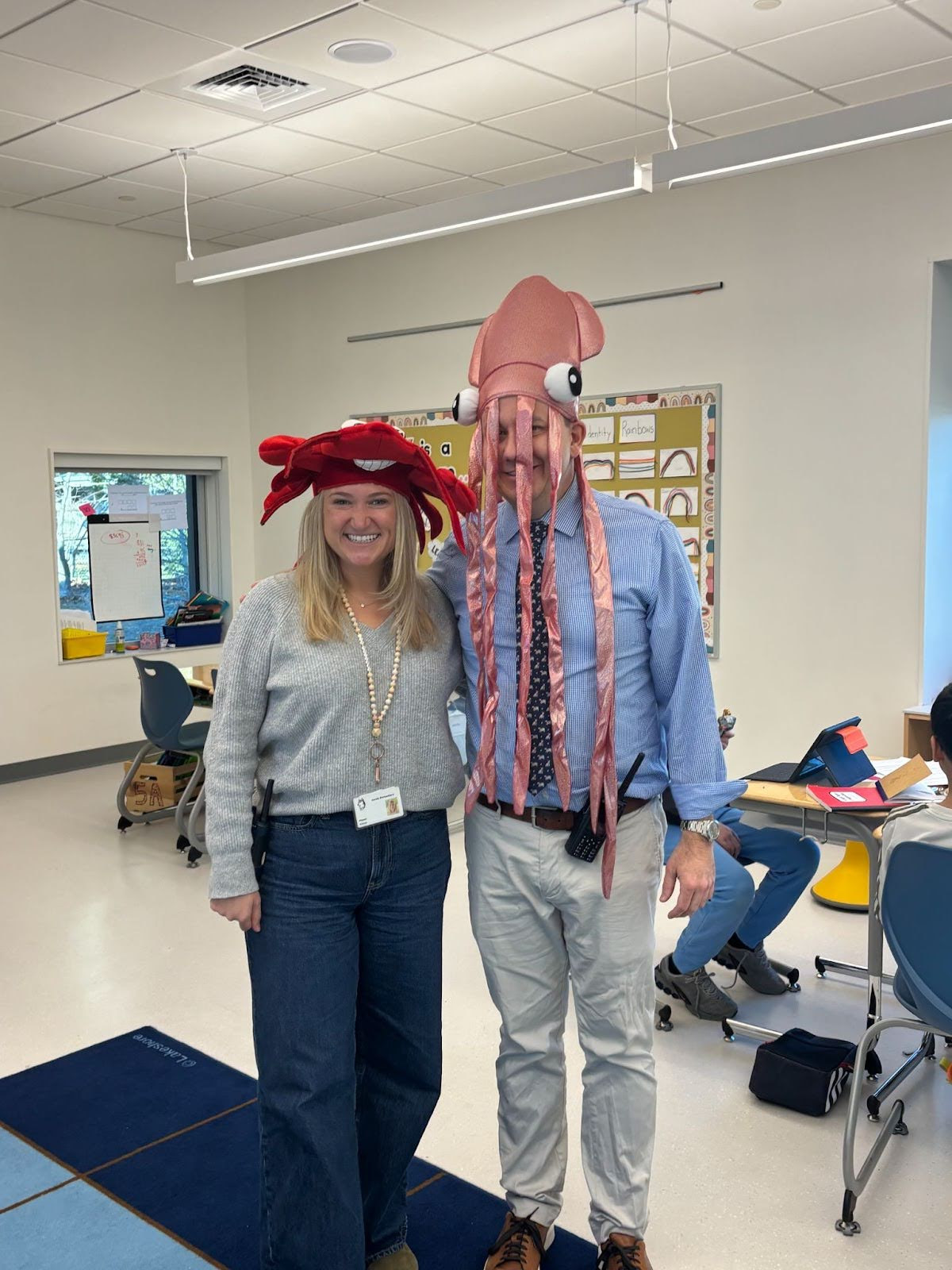 Mrs. Polcari wears a lobster hat and Mr. Smith wears a squid hat in celebration of Crazy Hat Day.