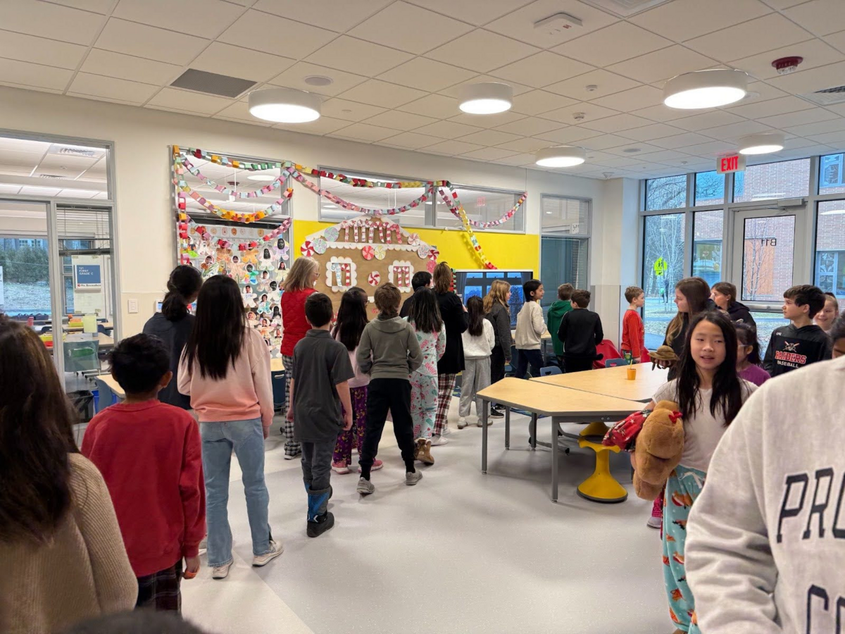Fourth graders visit the first grade pod during the Winter Gingerbread Stroll.
