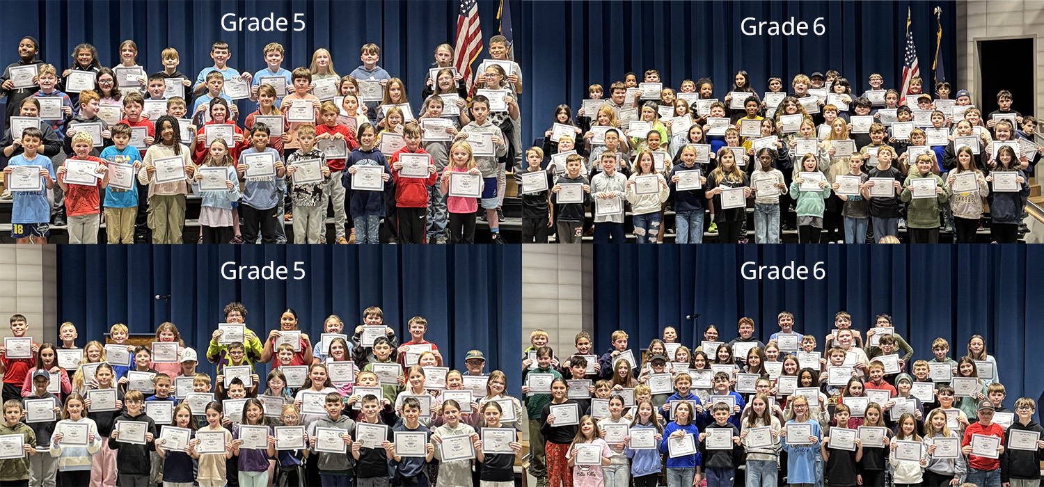Students in Grade 5 and Grade 6 pose for a photo, holding certificates on a stage with a blue curtain backdrop.