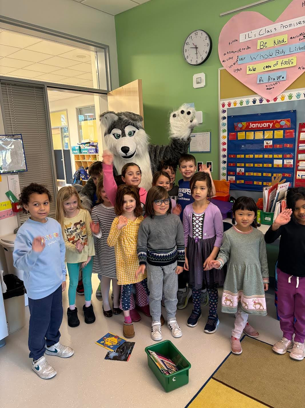 Students celebrate earning their Paws with Hero the Husky.