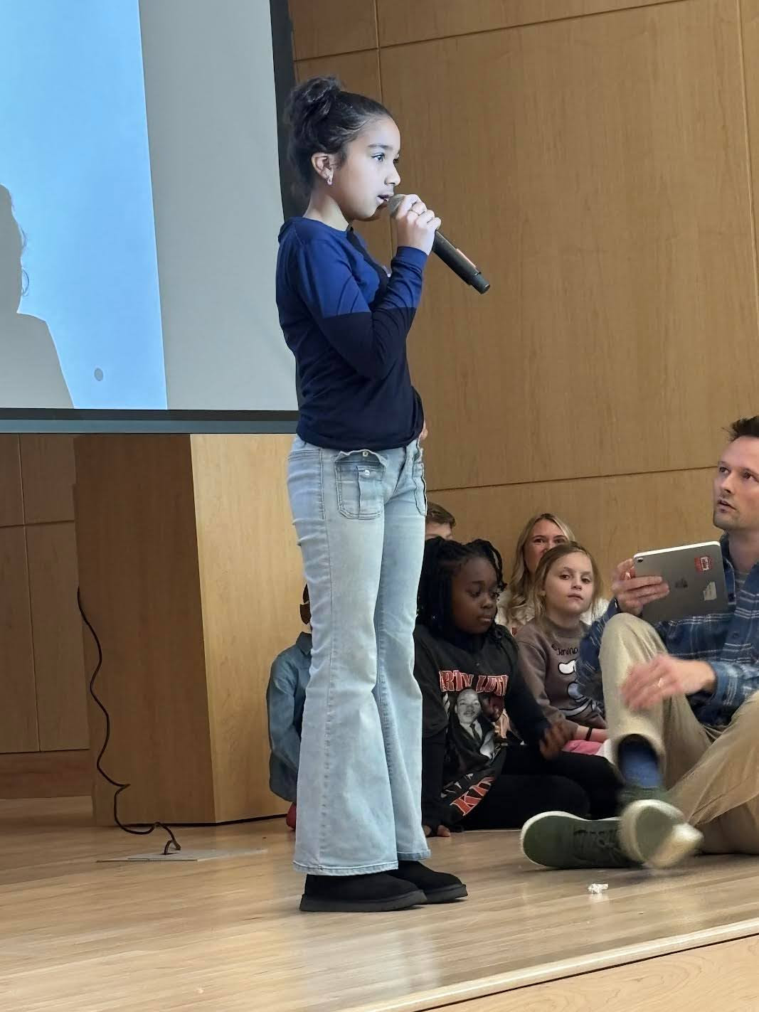 A student shows off her talent singing.