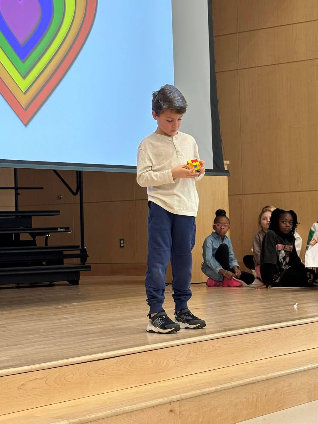 A student shows off his talent solving a Rubik's cube.