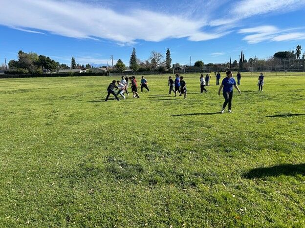 Image of students playing football during recess.