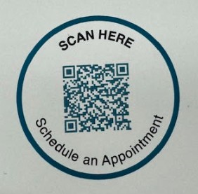 A circular sticker with a QR code and text 'SCAN HERE Schedule an Appointment'.