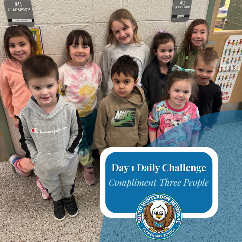 A group of diverse elementary school children stand together, smiling.