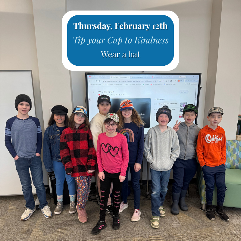 A group of children wearing various hats stand in front of a screen displaying 'Why Be Kind?'.