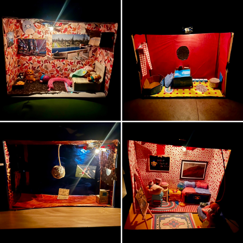 Four illuminated diorama scenes depict miniature rooms with various furnishings and decorations.