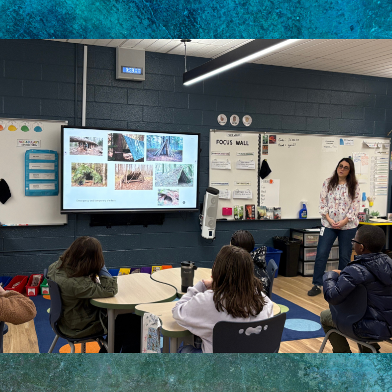 A teacher presents images of emergency shelters to a class of young students.