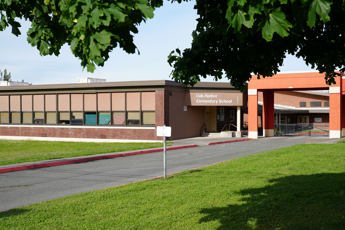 The front entrance of Oak Harbor Elementary School with a paved driveway and green lawn.