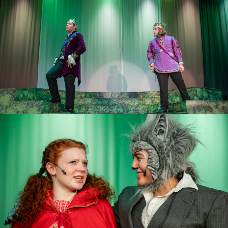 Two actors in regal purple costumes with crowns stand on a stage with green lighting.