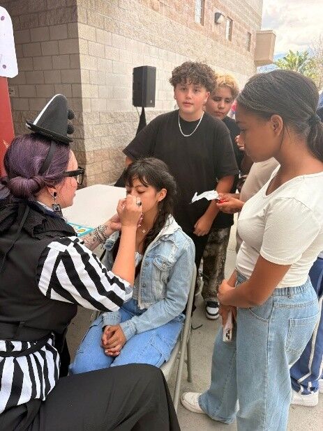 RCMS students at the Spring Carnival waiting in line for face painting.