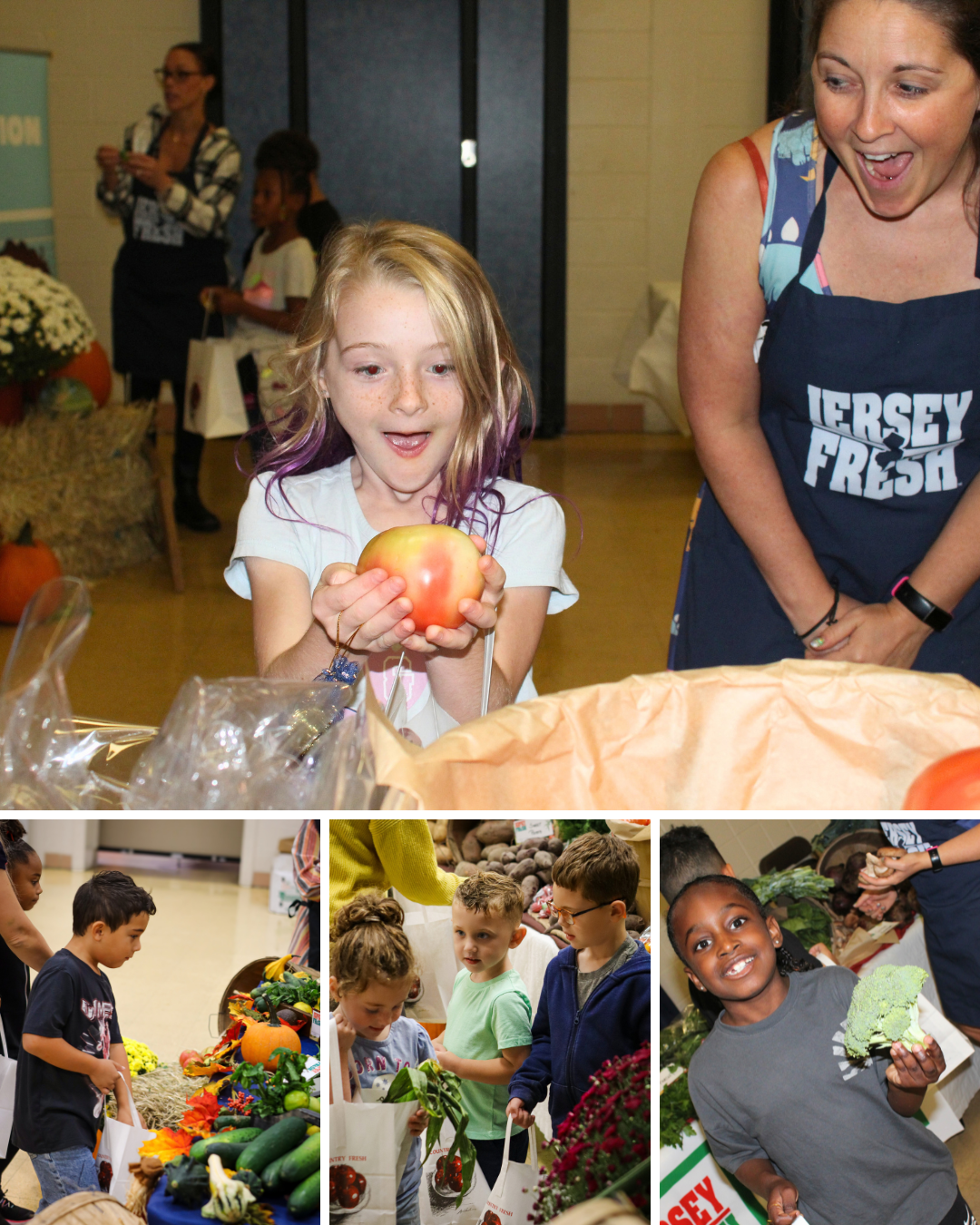 A young girl excitedly holds a large tomato as an adult looks on with delight in a community setting.