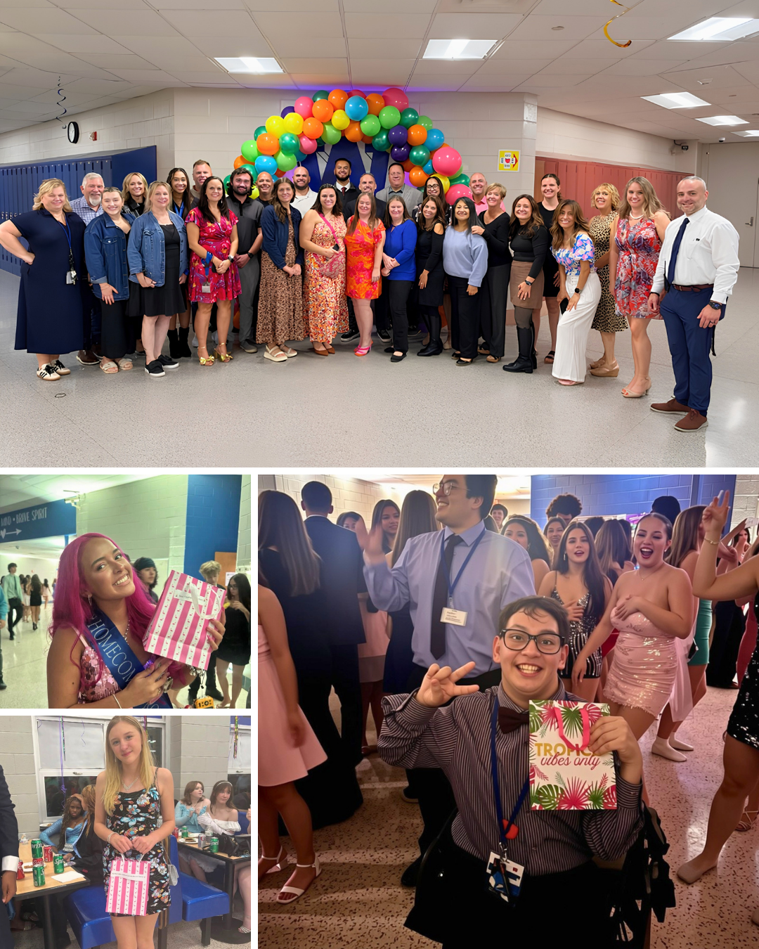 A large group of adults poses together in a school hallway with a colorful balloon arch behind them.