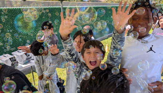 Smiling students participating in the bubble run.