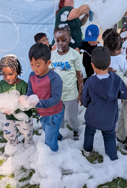 Students playing with suds.