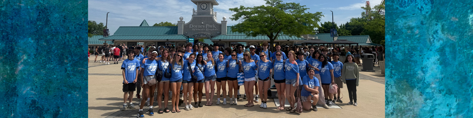 A group of young people in blue 'Class of 2023' t-shirts stand in front of the Dorney Park & Wildwater Kingdom entrance.