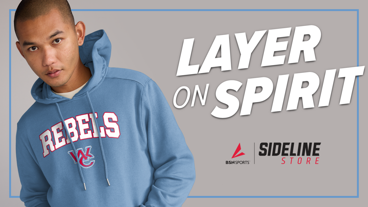 A person wearing a blue 'REBELS' hoodie stands against a grey background with the text 'LAYER ON SPIRIT'.