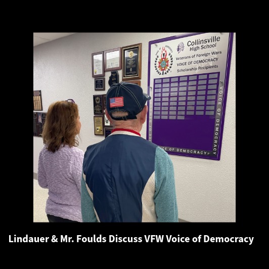 Two individuals, Lindauer and Mr. Foulds, stand before a wall display at Collinsville High School.