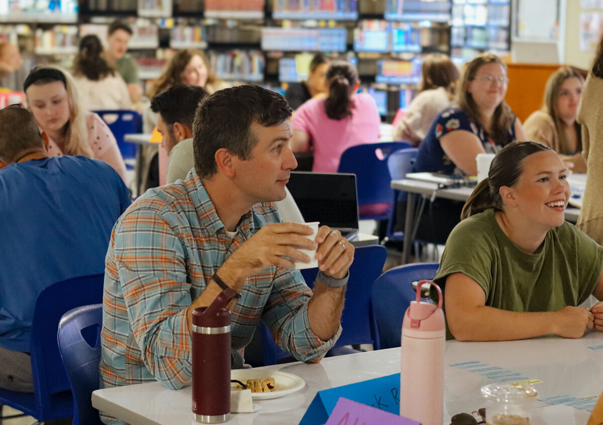 two people at table talking in school