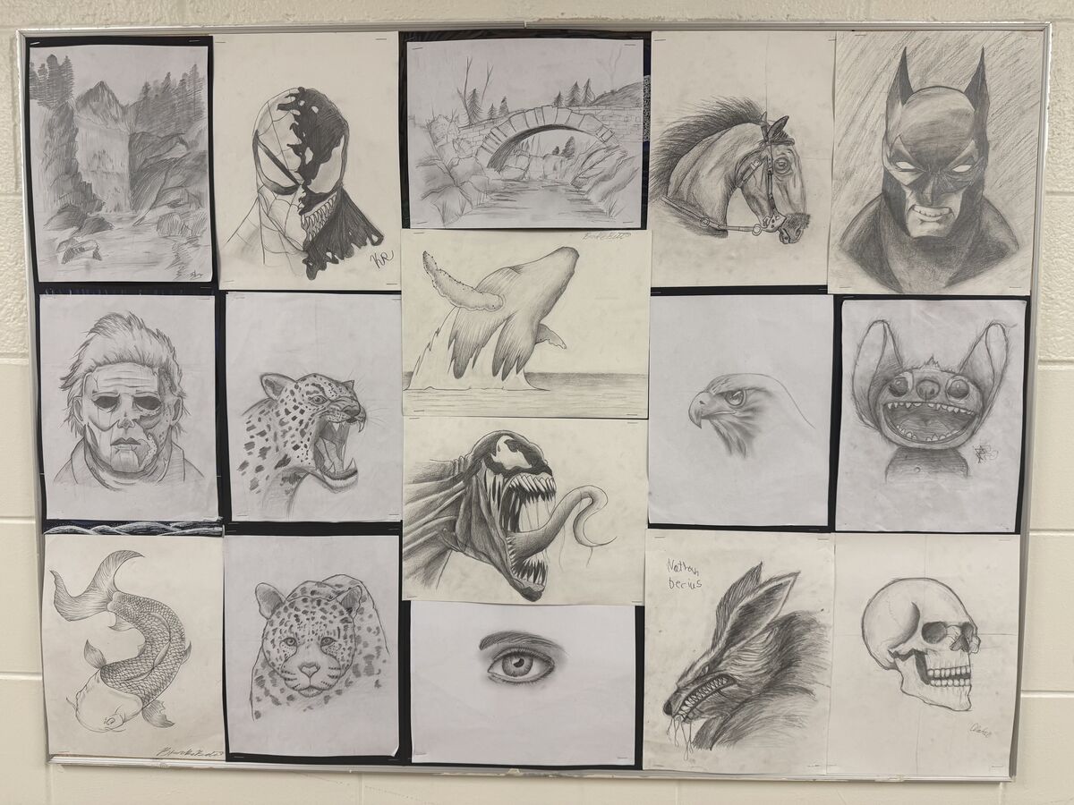 A bulletin board displays a collection of diverse pencil drawings by students.