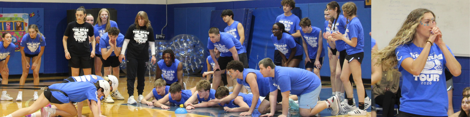 A group of young people in blue t-shirts with 'The Eras Tour 2026' printed on them participate in a game on a gymnasium floor.