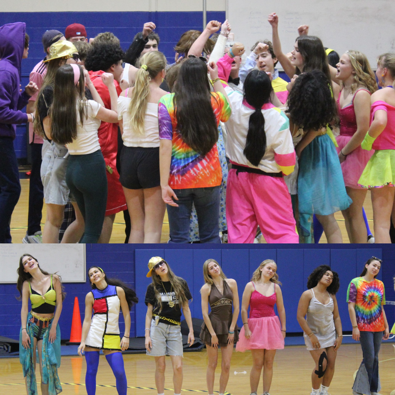 A group of young people in colorful, retro-inspired outfits pose with raised fists.