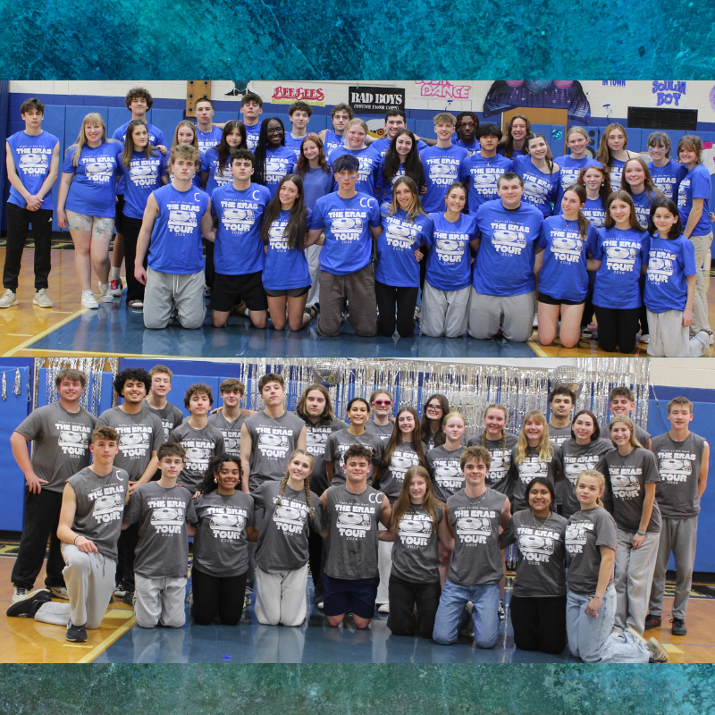 A large group of young people in matching blue t-shirts pose for a photo in a gymnasium.