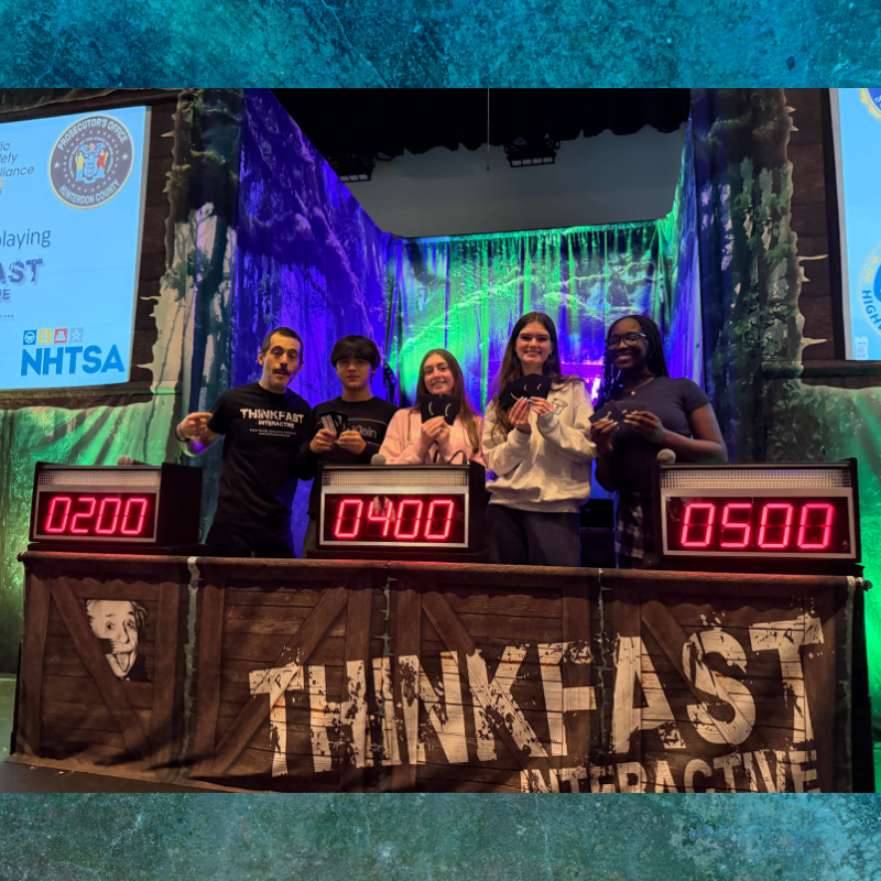 Five young people stand behind podiums with digital scoreboards displaying 0200, 0400, and 0500.