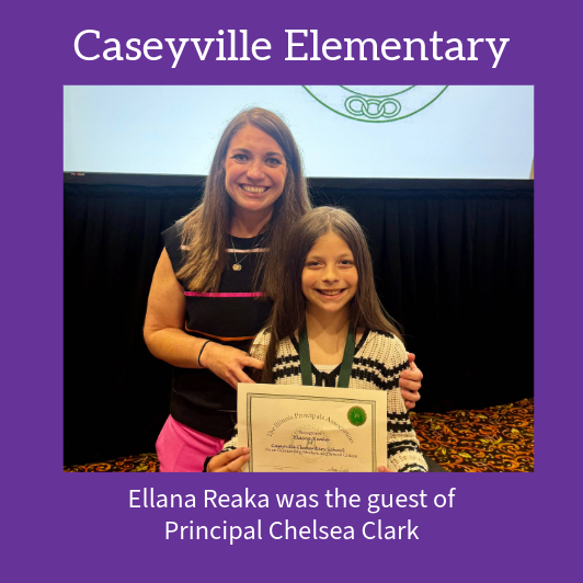 A smiling student holds a certificate while standing with Principal Chelsea Clark.