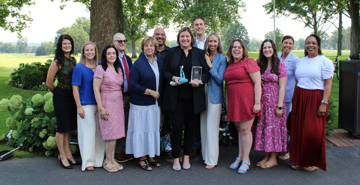A group of people stand together outdoors