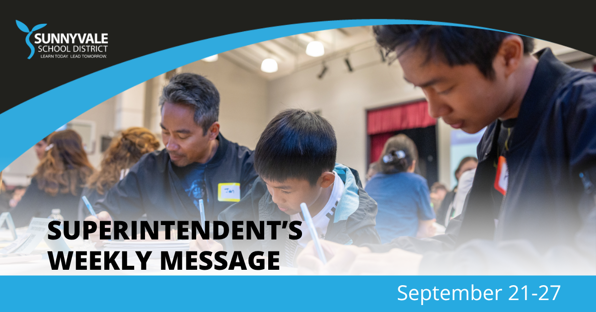 A teacher and students are engaged in writing activities in a brightly lit classroom.