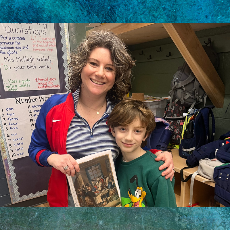 An adult and child pose for a photo together. 